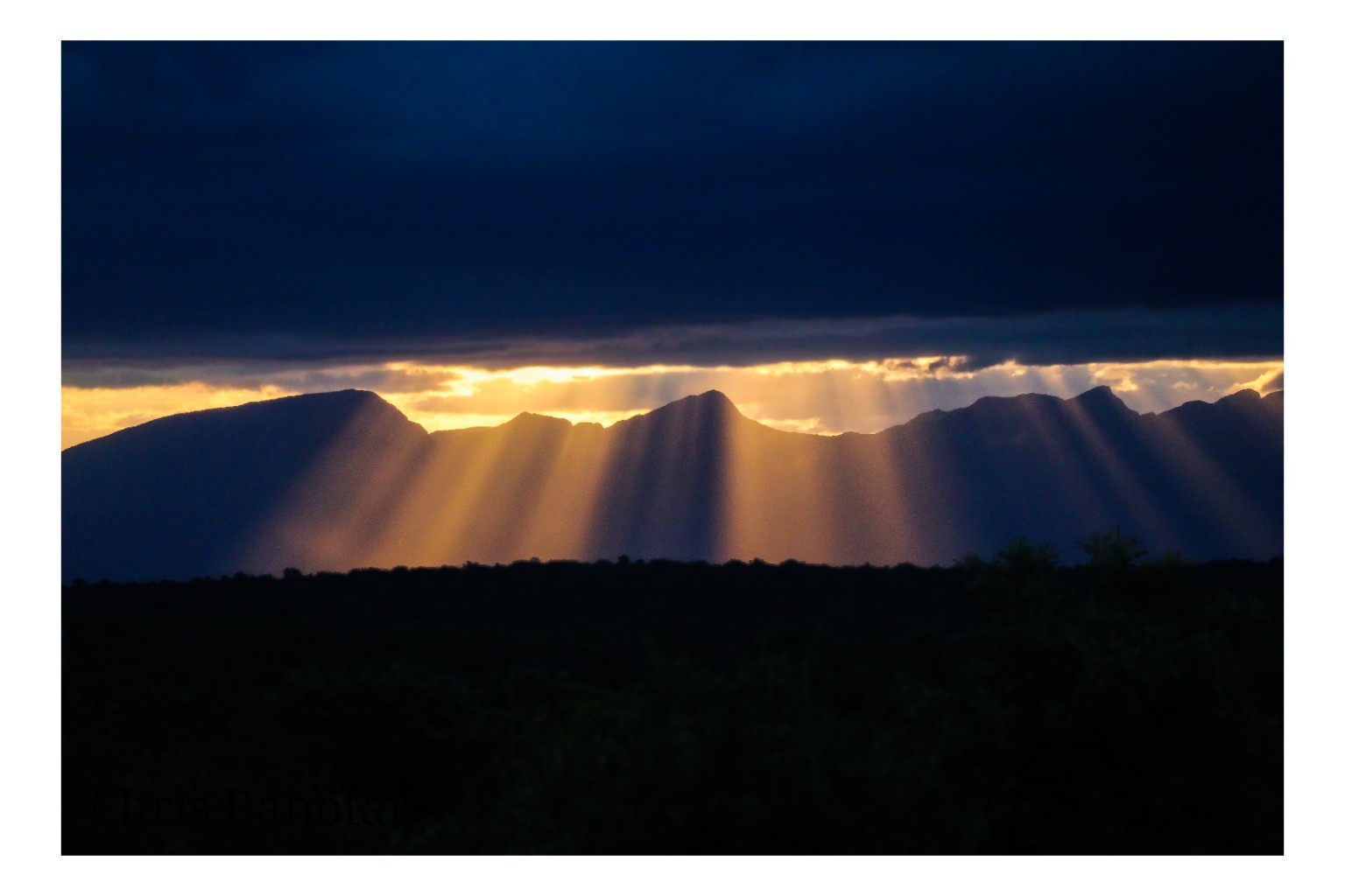 Sunlight breaking through clouds over the Drakensberg escarpment, South Africa