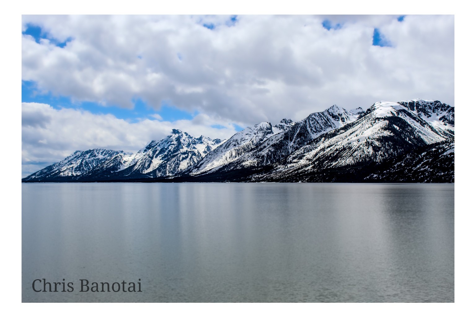 Teton Range reflected across a cold mountain lake, Wyoming